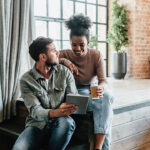 Couple in modern loft using tablet.