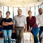 Group of five confident people in a conference room.