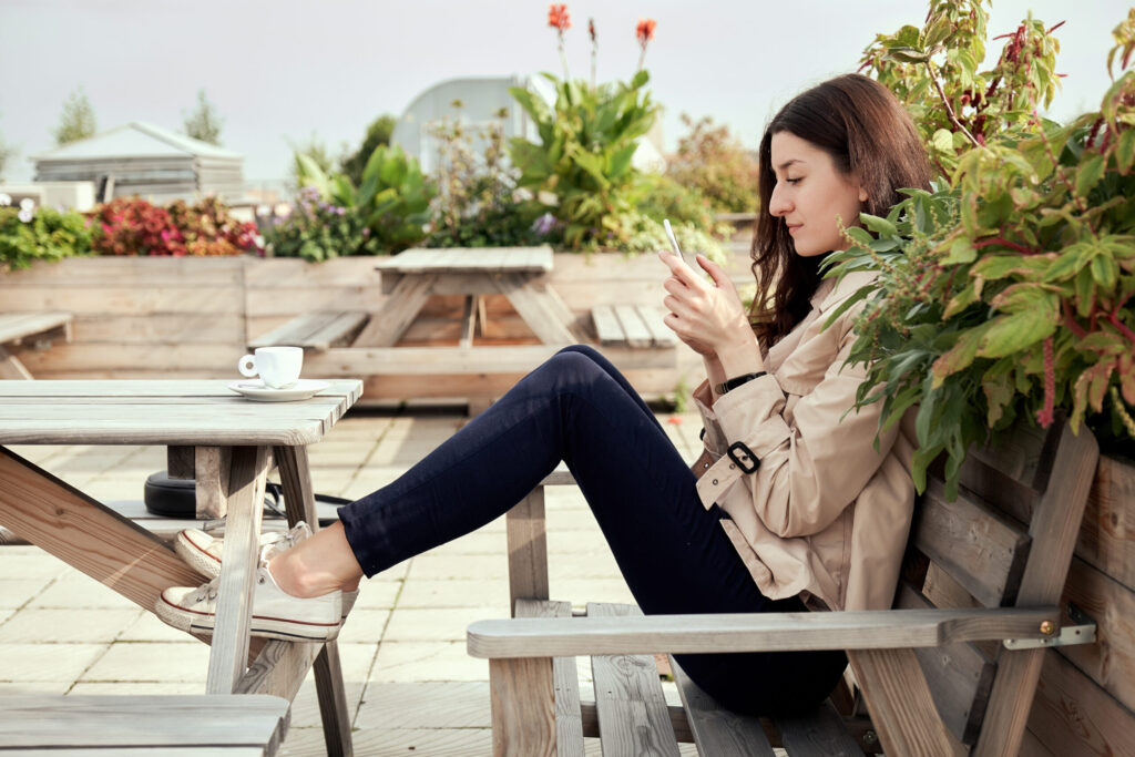 women using her phone to shop for a new home